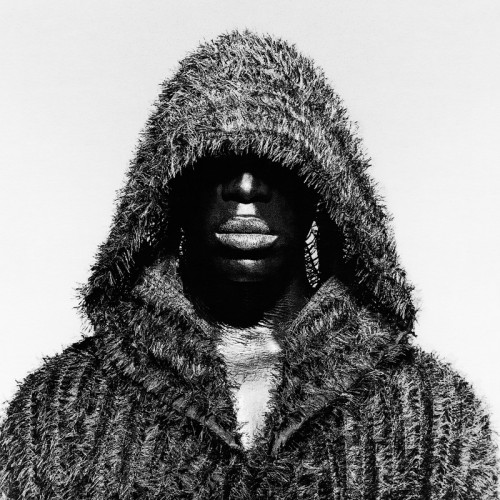 Black male wearing hooded coat black and white portrait photography by photographer Kenneth Rimm